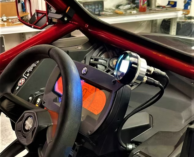 Razorback technology gage with  a Razorback mount bracket installed in a CanAm X3 (x-series).